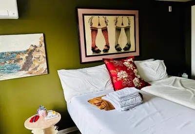 a cat laying on a bed in a room at Heart of Fishtown with parking! in Philadelphia