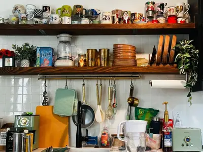 a kitchen counter with dishes and utensils on a shelf at Heart of Fishtown with parking! in Philadelphia