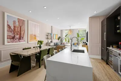 a kitchen and living room with a table and chairs at Greenwich Village Gem in New York