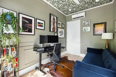 a home office with a desk and a blue couch at Greenwich Village Gem in New York