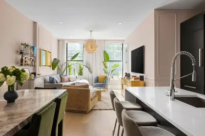 a kitchen and living room with a sink and a couch at Greenwich Village Gem in New York