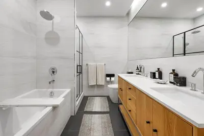 a bathroom with two sinks and a tub and a toilet at Greenwich Village Gem in New York