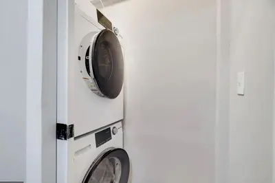 two washing machines are next to a wall at Amazing Condo with hot tub and screened in porch 8 passes to lake and beach in Stoddartsville