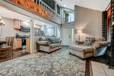 a living room with two chairs and a couch at Amazing Condo with hot tub and screened in porch 8 passes to lake and beach in Stoddartsville
