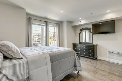 a bedroom with a bed and a dresser and a window at Remote Work Hub Philly Condo 3 Mi to Center City! in Philadelphia