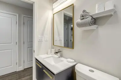 a bathroom with a sink and a mirror at Remote Work Hub Philly Condo 3 Mi to Center City! in Philadelphia