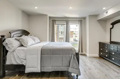 a bedroom with a bed and a dresser and a window at Remote Work Hub Philly Condo 3 Mi to Center City! in Philadelphia