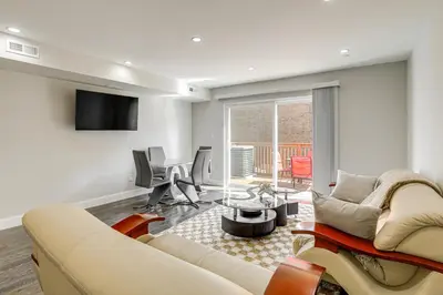 a living room with a couch and a table at Remote Work Hub Philly Condo 3 Mi to Center City! in Philadelphia