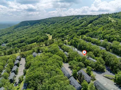 an aerial view of a forested area with a road at 108 Escape: Ski-In, Chill-Out |Waterparks & Hiking in Tannersville