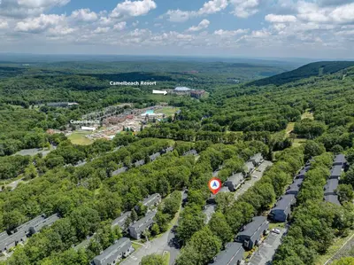 an aerial view of a city with trees and cars at 108 Escape: Ski-In, Chill-Out |Waterparks & Hiking in Tannersville