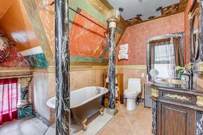 a bathroom with a tub and a toilet and a sink at A Retreat in an Historic Estate with Modern Comforts in Scranton