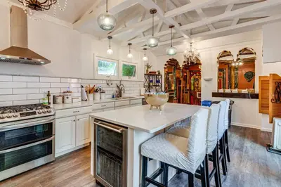 a kitchen with a large island with bar chairs at A Retreat in an Historic Estate with Modern Comforts in Scranton
