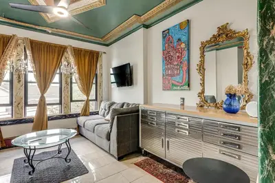 a living room with a couch and a mirror at A Retreat in an Historic Estate with Modern Comforts in Scranton