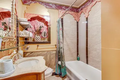 a bathroom with a sink and a tub and a toilet at A Retreat in an Historic Estate with Modern Comforts in Scranton