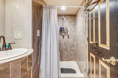 a bathroom with a shower and a sink at A Retreat in an Historic Estate with Modern Comforts in Scranton