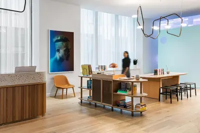 a woman in a room with a table and chairs at Mint House 70 Pine by Kasa in New York