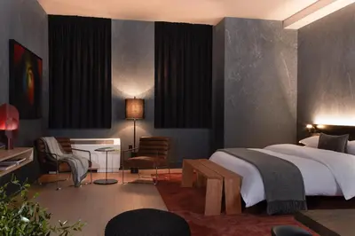 a bedroom with a bed and a desk and chairs at Mint House 70 Pine by Kasa in New York