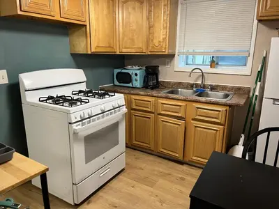 a kitchen with a stove and a sink at Cozy Efficiency Room WalktoUHS, near BU Guthrie in Johnson City