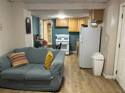 a living room with a couch and a refrigerator at PR near Lourdes and UHS Hospital in Johnson City