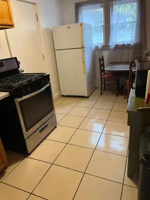 a kitchen with a stove and a refrigerator at Spacious, Unique PR near Binghamton University in Johnson City