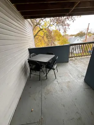 a patio with a table and chairs on a balcony at Relaxing, Calming PR by Binghamton University in Johnson City