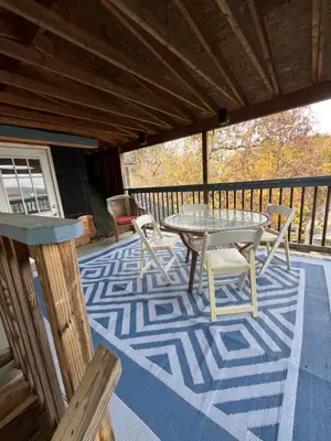 a patio with a table and chairs on a deck at Relaxing, Calming PR by Binghamton University in Johnson City