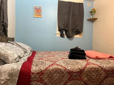 a bedroom with a bed with a quilt on it at Fanciful, Comfy Private Room - Lourdes Hospital in Johnson City