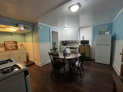 a kitchen with a table and chairs and a refrigerator at Fanciful, Comfy Private Room - Lourdes Hospital in Johnson City