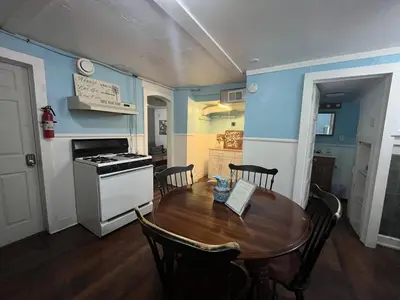 a kitchen and dining room with a wooden table with chairs at Fanciful, Comfy Private Room - Lourdes Hospital in Johnson City