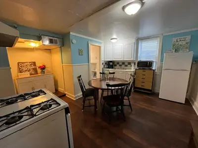 a kitchen with a table and a white stove top oven at Intimate PR near Binghamton University. Free Park in Johnson City