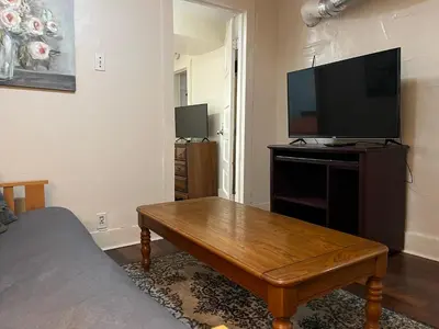 a living room with a television and a wooden coffee table at Intimate PR near Binghamton University. Free Park in Johnson City