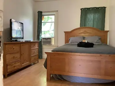 a bedroom with a bed with a television and a dresser at Lovely PR near Lourdes Hospital by Binghamton in Johnson City