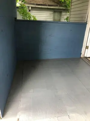 a garage with a blue wall and a driveway at Lovely PR near Lourdes Hospital by Binghamton in Johnson City