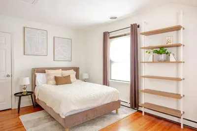 a bedroom with a bed and a book shelf at Elegant Spacious Retreat Perfect For Families in Wilmington