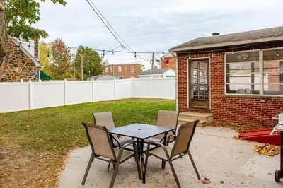 a patio with a table and chairs in a yard at Elegant Spacious Retreat Perfect For Families in Wilmington