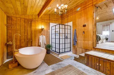 a large bathroom with a tub and a shower at Ski, Swim, Relax Old-Fashioned Poconos Getaway in Pocono Pines