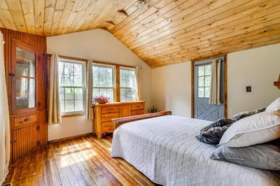 a bedroom with a bed and a wooden ceiling at Ski, Swim, Relax Old-Fashioned Poconos Getaway in Pocono Pines