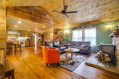 a living room with leather furniture and a fireplace at Ski, Swim, Relax Old-Fashioned Poconos Getaway in Pocono Pines