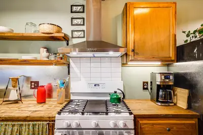 a kitchen with a stove top oven in a kitchen at Ski, Swim, Relax Old-Fashioned Poconos Getaway in Pocono Pines