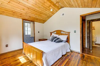 a bedroom with a bed and a wooden ceiling at Ski, Swim, Relax Old-Fashioned Poconos Getaway in Pocono Pines