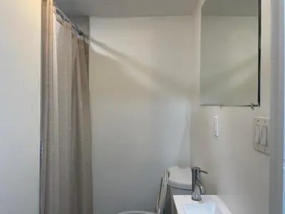 a bathroom with a sink and a toilet and a mirror at 1711 Edgley Street in Philadelphia