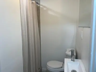 a white bathroom with a toilet and a sink at 1711 Edgley Street in Philadelphia