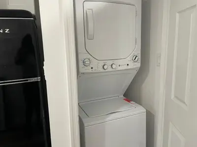a washer and dryer sitting next to a refrigerator at 1711 Edgley Street in Philadelphia
