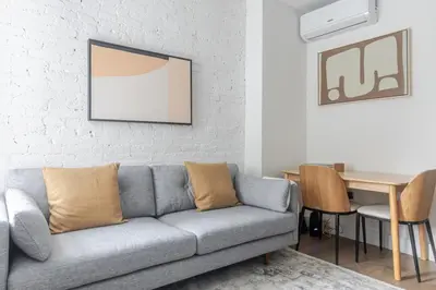 a living room with a couch and a table at Blueground Alphabet City view nr Tompkins Sq Park NYC-1884 in New York