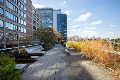 a sidewalk in a city with benches and buildings at Blueground Chelsea rooftop nr Highline NYC-369 in New York