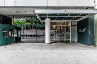 a glass entrance to a building with a pole at Blueground Midtown South rooftop nr Bryant Park NYC-2028 in New York