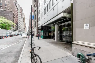 a bike parked on a sidewalk next to a street at Blueground Midtown South rooftop nr Bryant Park NYC-2028 in New York