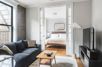 a living room with a couch and a bed at Blueground Nolita private entrance nr Bowery NYC-2054 in New York