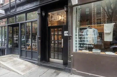 a store front with the doors open on a street at Blueground Nolita private entrance nr Bowery NYC-2054 in New York