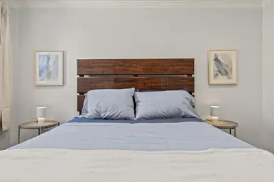 a bedroom with a bed with two side tables at The Bella Vista Townhouse in Philadelphia